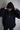 front view of black hoodie HUG by me&amp;rch